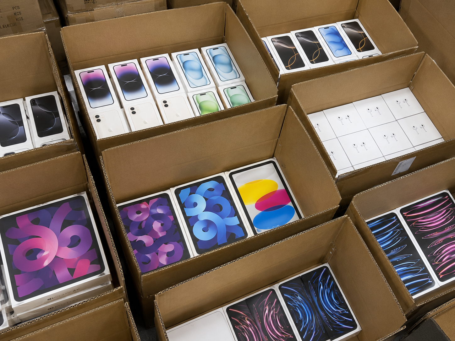 Flat lay of sealed Apple retail product boxes
